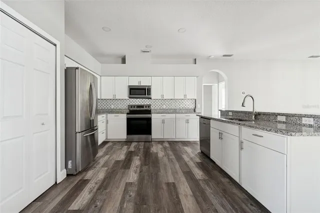 a view of a room with wooden floor and window