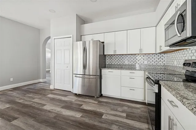 a view of a hallway with wooden floor and closet