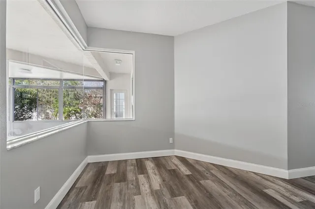 a view of a room with wooden floor and window