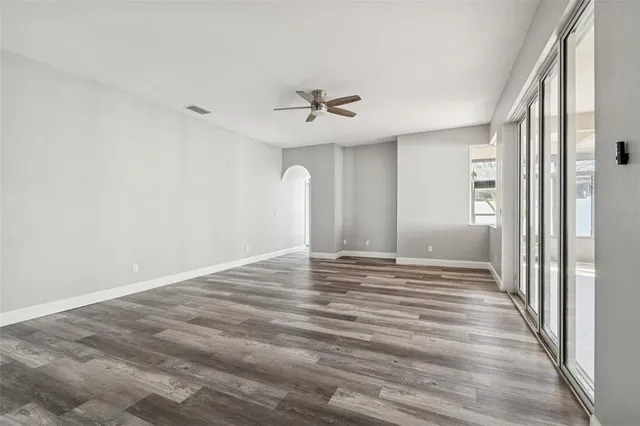 wooden floor in an empty room with a window