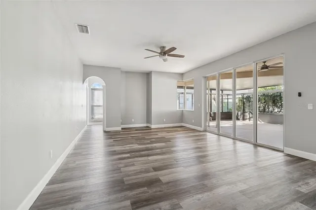 a view of an empty room with floor to ceiling window and an outdoor view