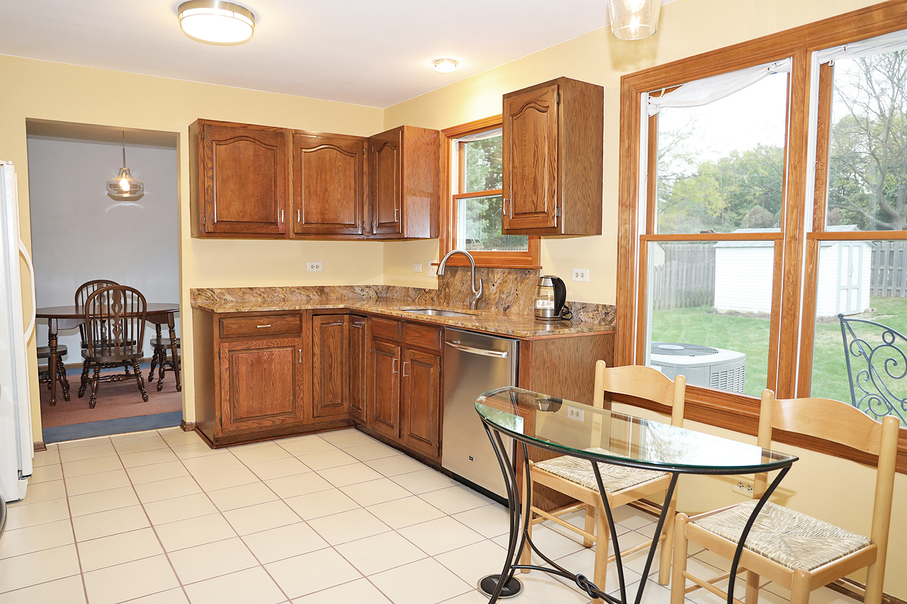 400 Barton Place Carol Stream, IL 60188 - Photo 12 of 45 a kitchen with a table chairs and a sink