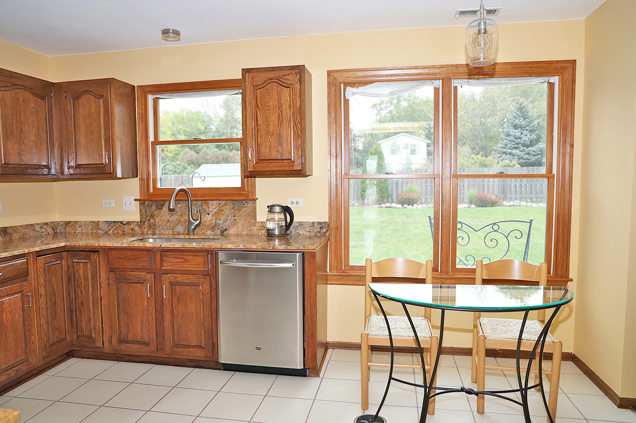 400 Barton Place Carol Stream, IL 60188 - Photo 14 of 45 a kitchen with a window a sink and cabinets
