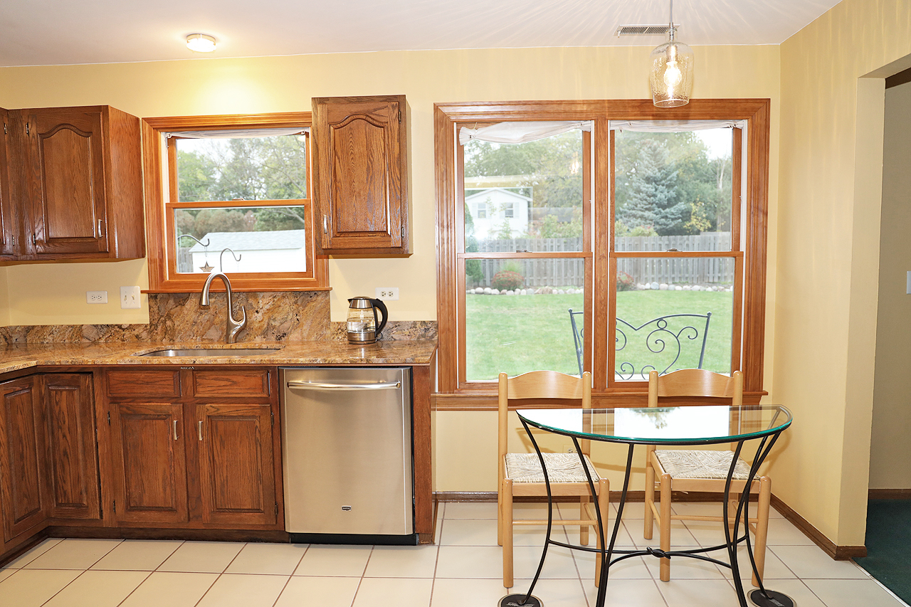 400 Barton Place Carol Stream, IL 60188 - Photo 15 of 45 a kitchen with a window a sink and chairs