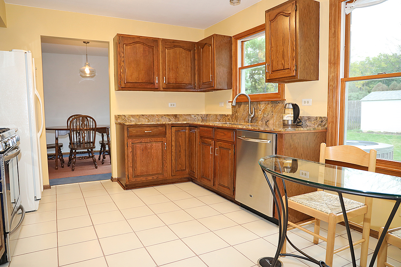 400 Barton Place Carol Stream, IL 60188 - Photo 17 of 45 a kitchen with stainless steel appliances granite countertop a stove top oven a sink and a window