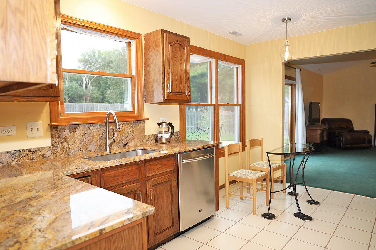 400 Barton Place Carol Stream, IL 60188 - Photo 18 of 45 a kitchen with a sink and chairs