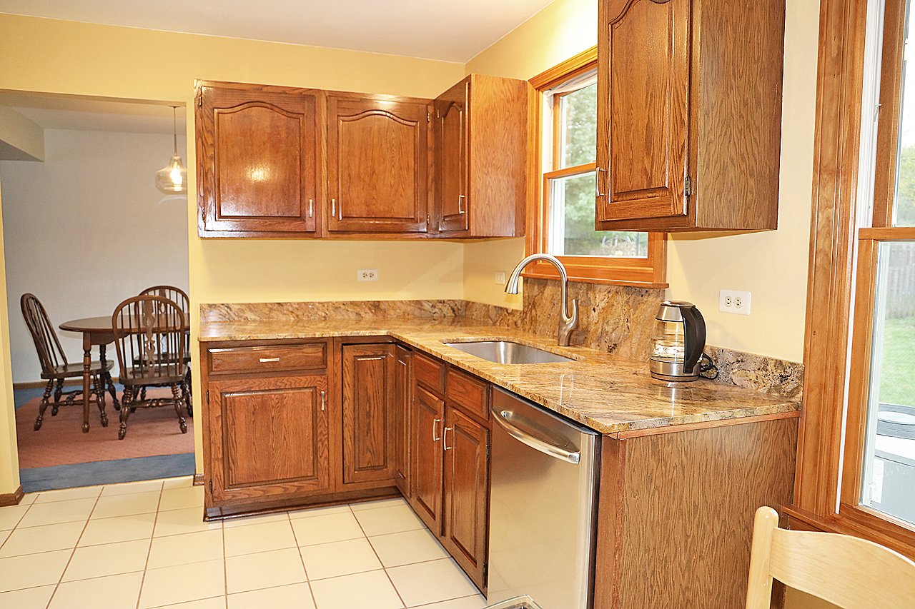 400 Barton Place Carol Stream, IL 60188 - Photo 19 of 45 a kitchen with stainless steel appliances granite countertop a sink and cabinets