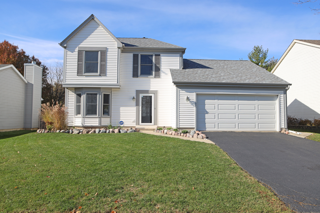 400 Barton Place Carol Stream, IL 60188 - Photo 2 of 45 a front view of a house with a garden
