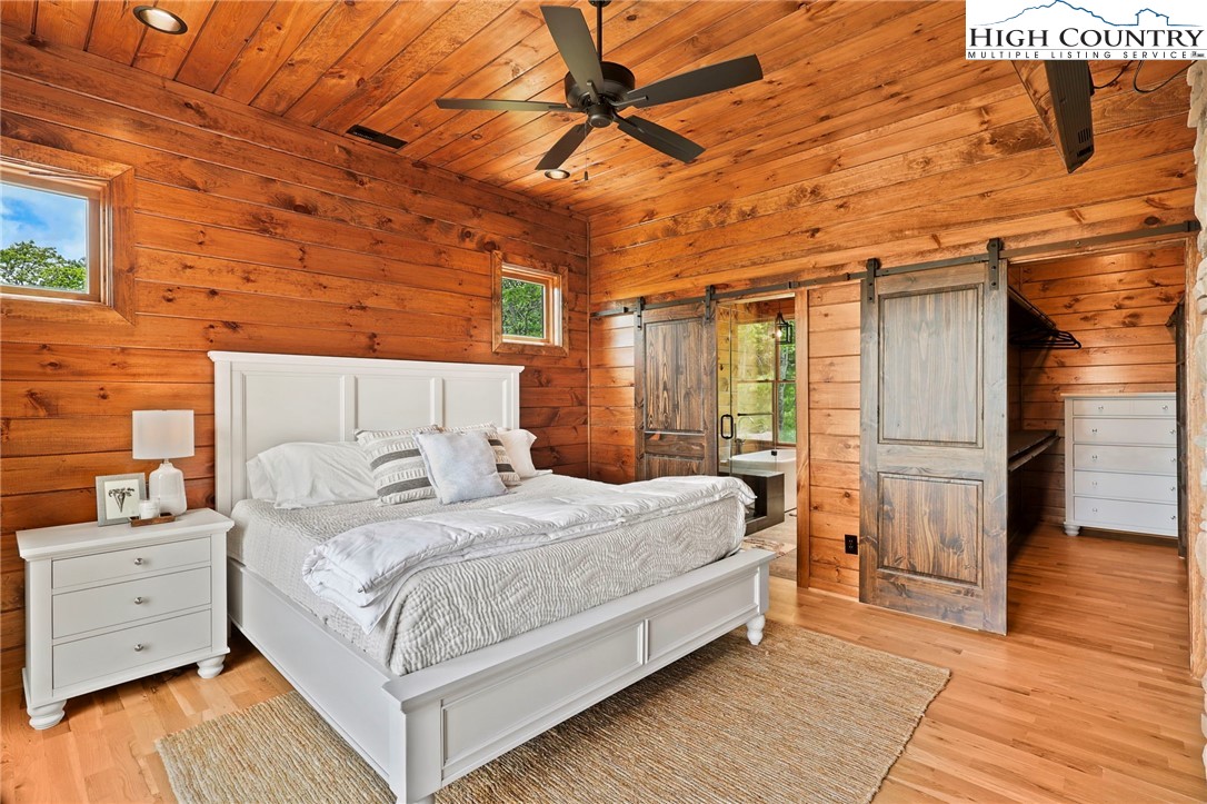 543 Broken Arrow Trail Boone, NC 28607 - Photo 15 of 46 a bedroom with a bed and a table