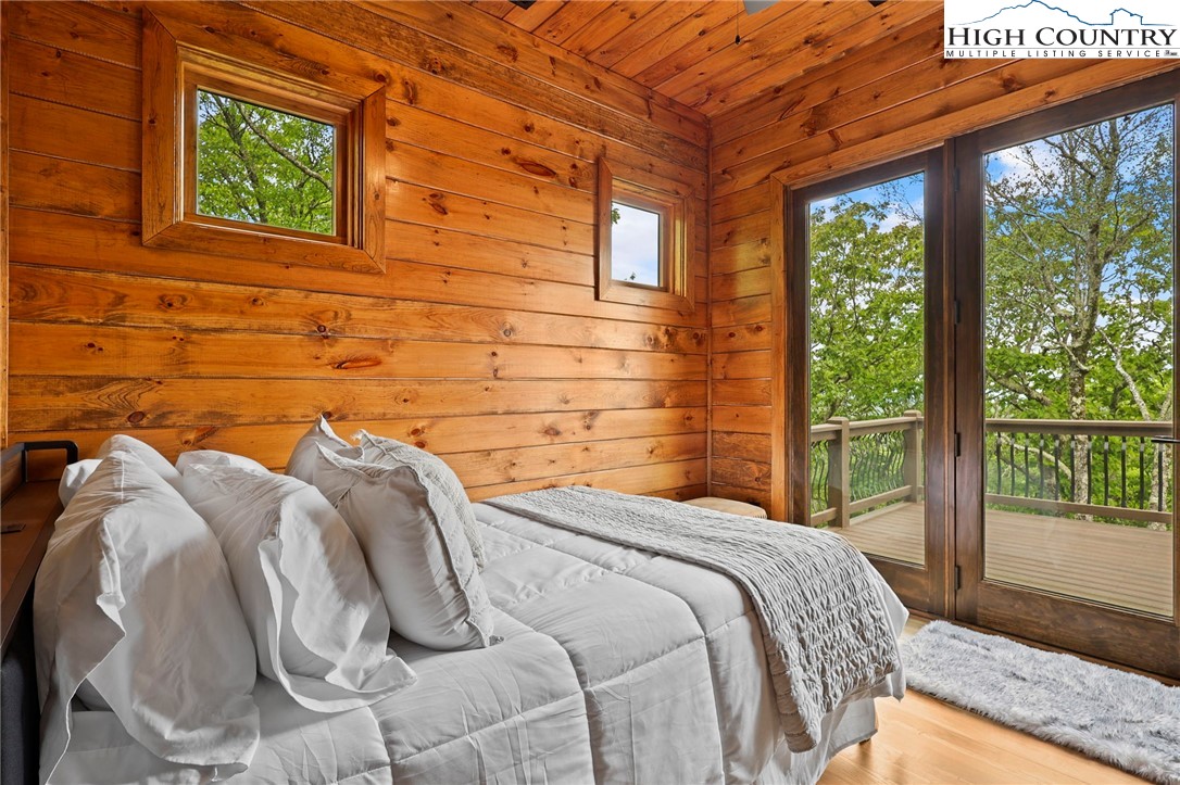 543 Broken Arrow Trail Boone, NC 28607 - Photo 21 of 46 a bed sitting in a bedroom next to a window