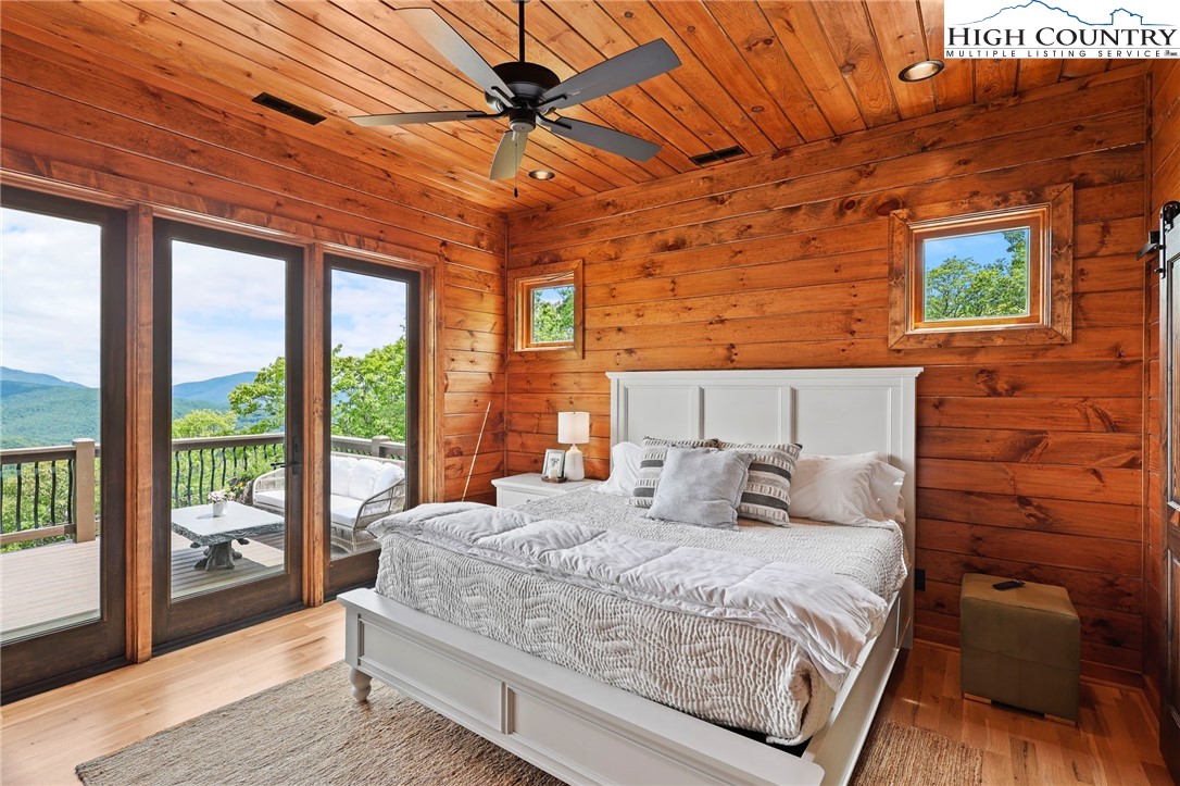 543 Broken Arrow Trail Boone, NC 28607 - Photo 23 of 46 a bedroom with a bed and wooden floor