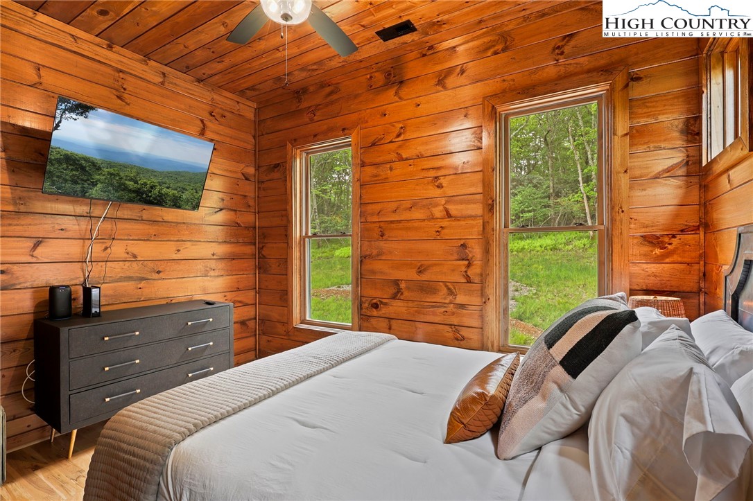 543 Broken Arrow Trail Boone, NC 28607 - Photo 27 of 46 a bedroom with a bed and flat screen tv