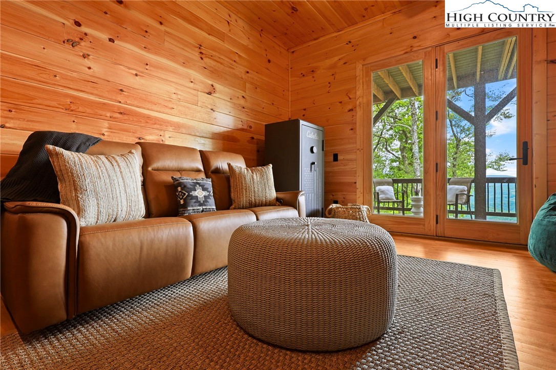 543 Broken Arrow Trail Boone, NC 28607 - Photo 29 of 46 a spacious bedroom with a bed and wooden floor