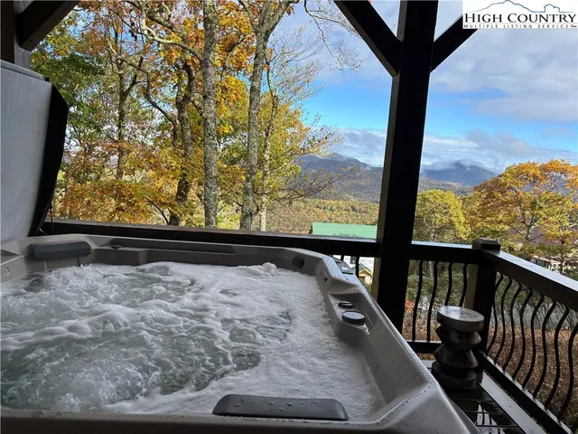 a view of a chairs and table on the wooden deck