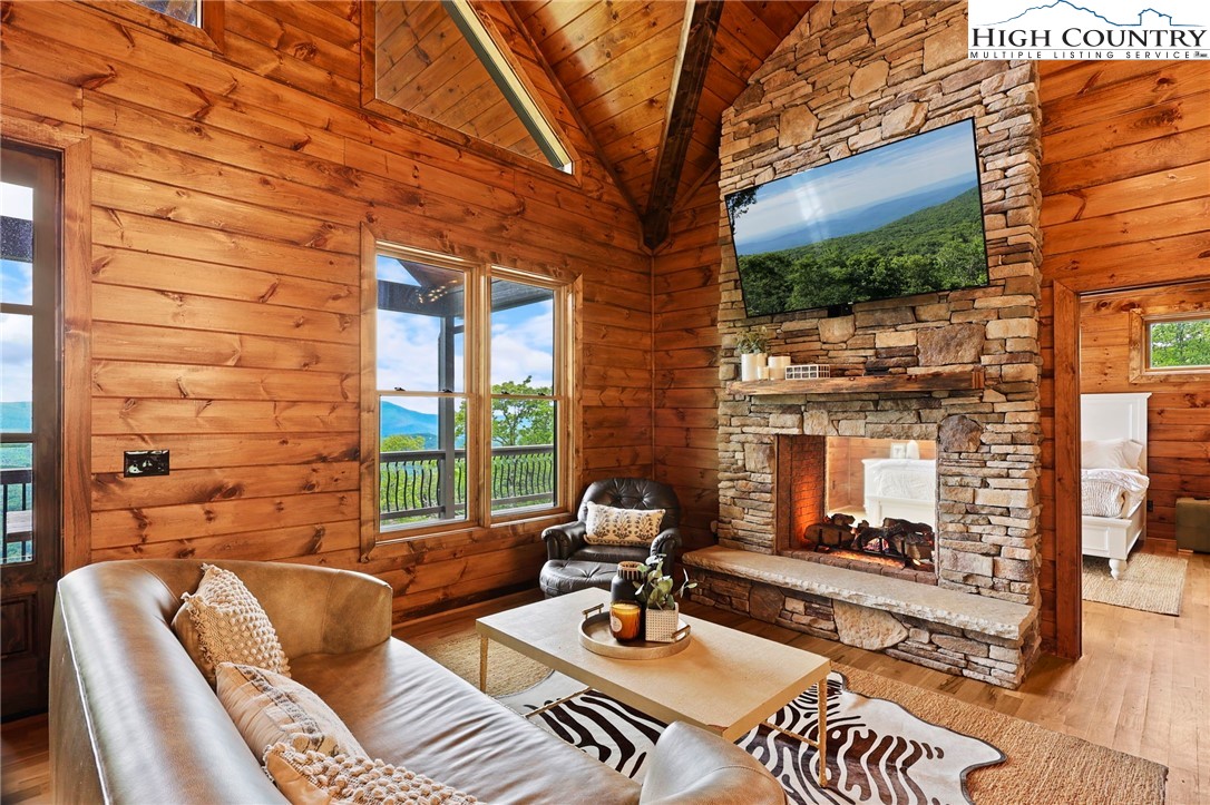 543 Broken Arrow Trail Boone, NC 28607 - Photo 6 of 46 a view of a patio with couches table and chairs and potted plants
