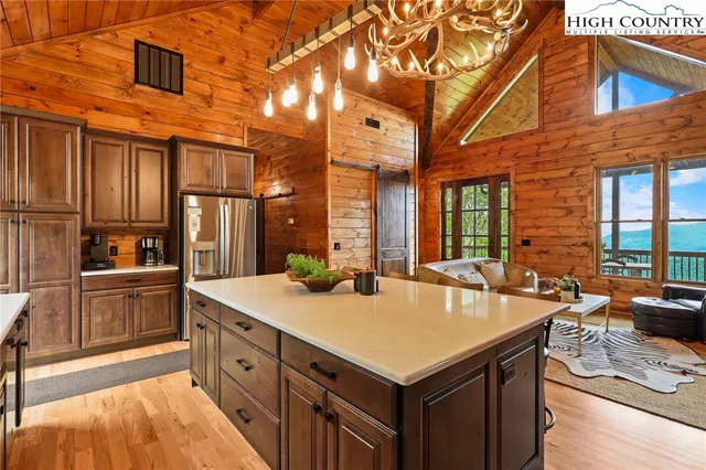 a dining hall with stainless steel appliances granite countertop a sink and a refrigerator