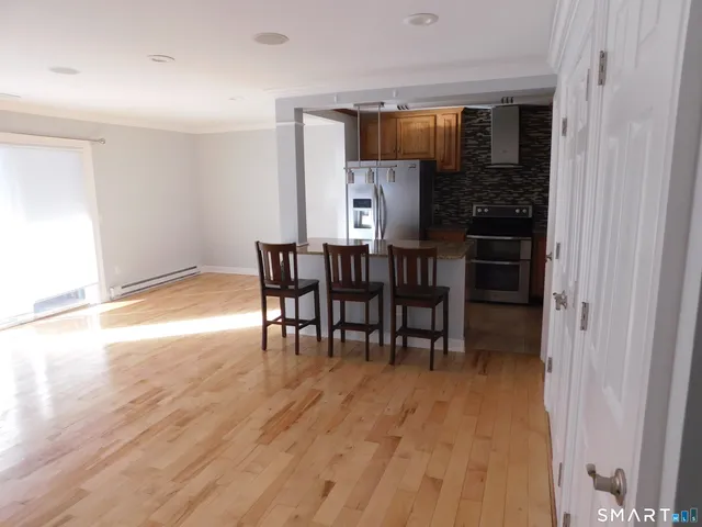 a view of a dining room with furniture and wooden floor