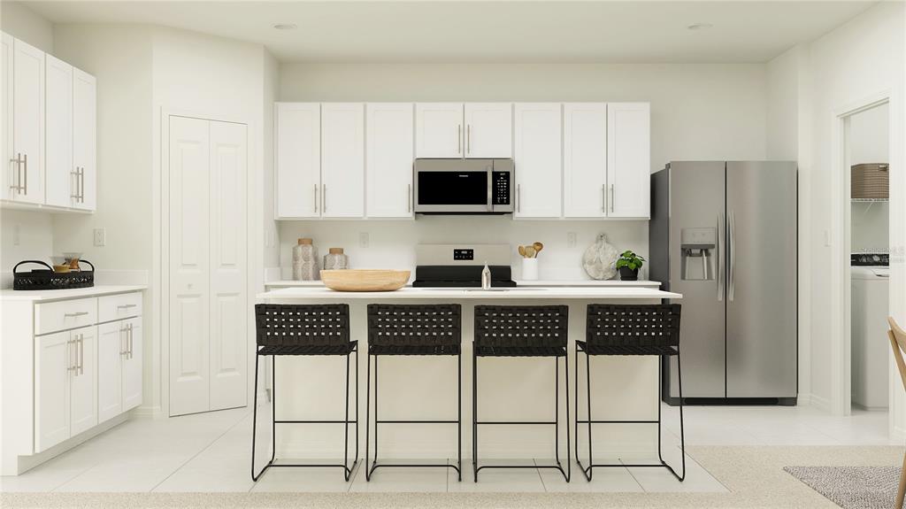 2422 Bluestone Road Haines City, FL 33844 - Photo 2 of 28 a kitchen with stainless steel appliances a stove a refrigerator and white cabinets