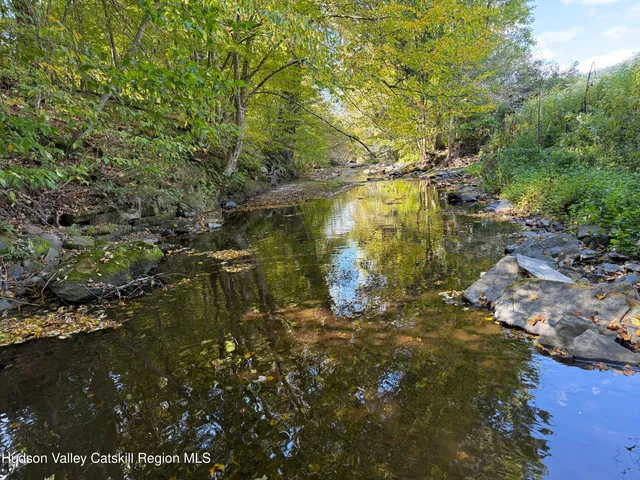 a swimming pool with some trees in the background