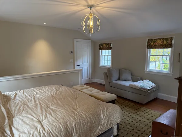 a bedroom with bed and a window