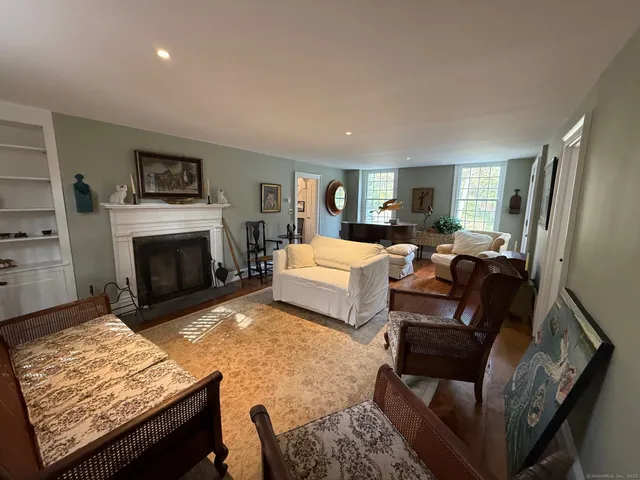 a living room with furniture and a piano