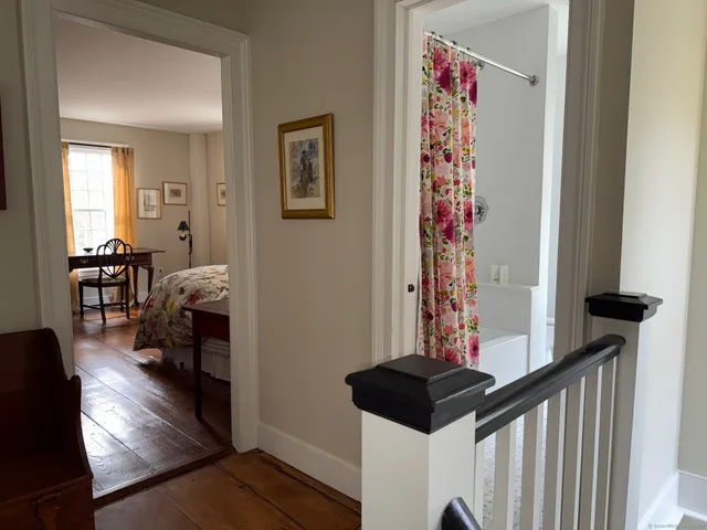 a view of entryway livingroom and hall with wooden floor