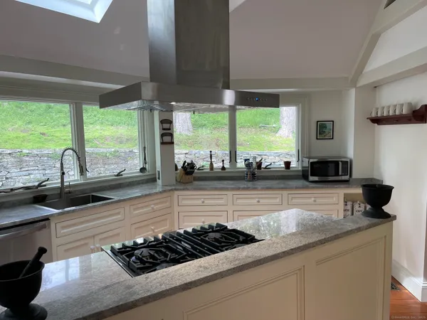 a kitchen with a stove and a wooden floor