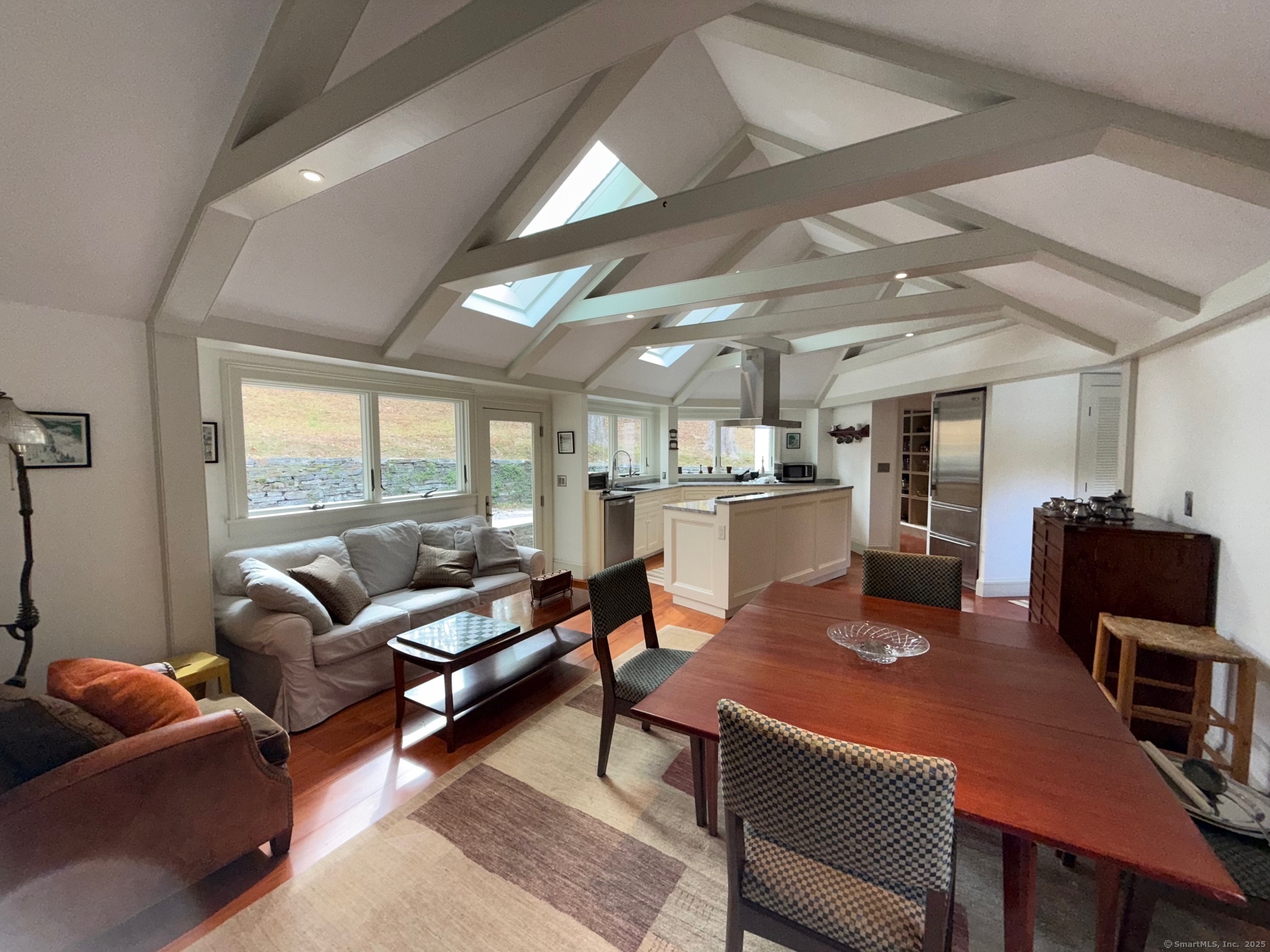 150 Ferry Road, Unit GATEHOUSE Lyme, CT 06371 - Photo 27 of 28 a living room with furniture a rug kitchen view and a large window