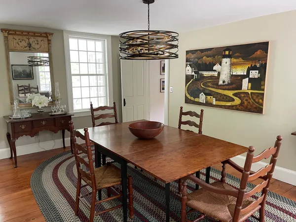 a view of a dining room with furniture and wooden floor