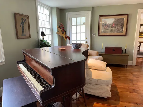 a living room with furniture and a piano