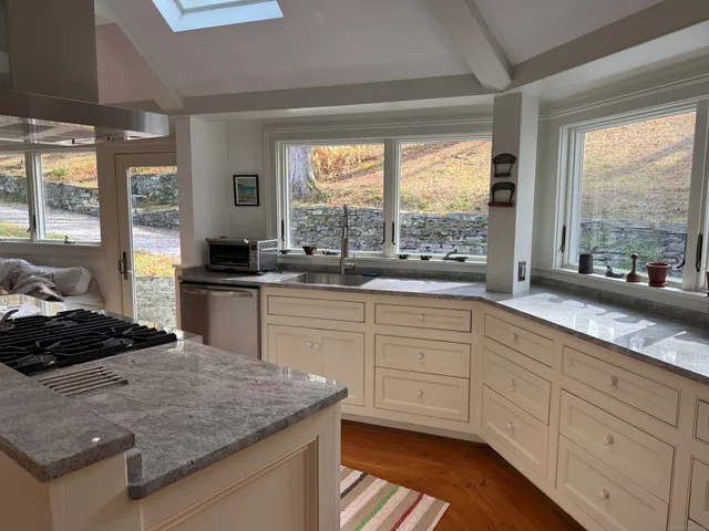 a kitchen with stainless steel appliances kitchen island sink stove and cabinets