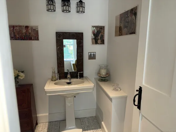 a bathroom with a sink toilet and mirror