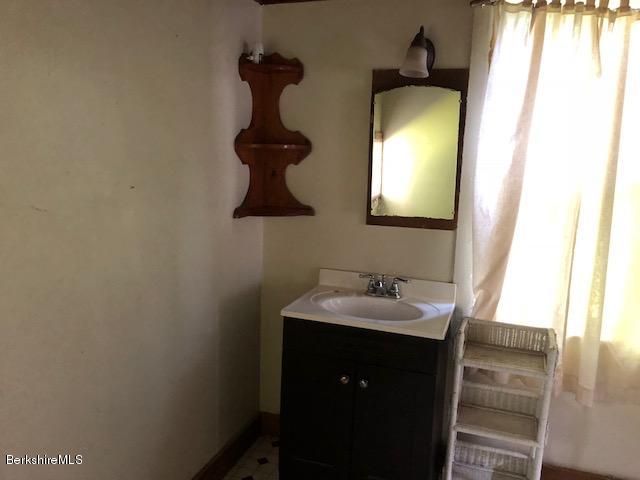 25 Sandisfield Road Sandisfield, MA 01255 - Photo 16 of 32 a bathroom with a sink and a mirror