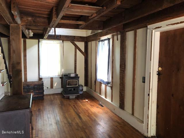 25 Sandisfield Road Sandisfield, MA 01255 - Photo 20 of 32 a living room with furniture next to a large window with wooden floor