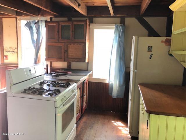 25 Sandisfield Road Sandisfield, MA 01255 - Photo 23 of 32 a kitchen with a stove a refrigerator and a window