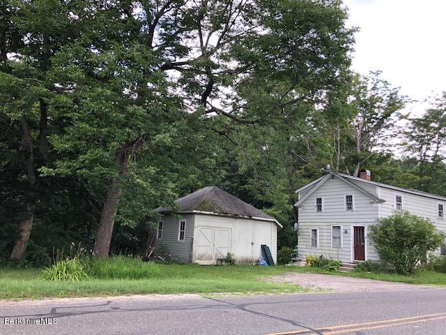25 Sandisfield Road Sandisfield, MA 01255 - Photo 25 of 32 a front view of a house with a garden and trees