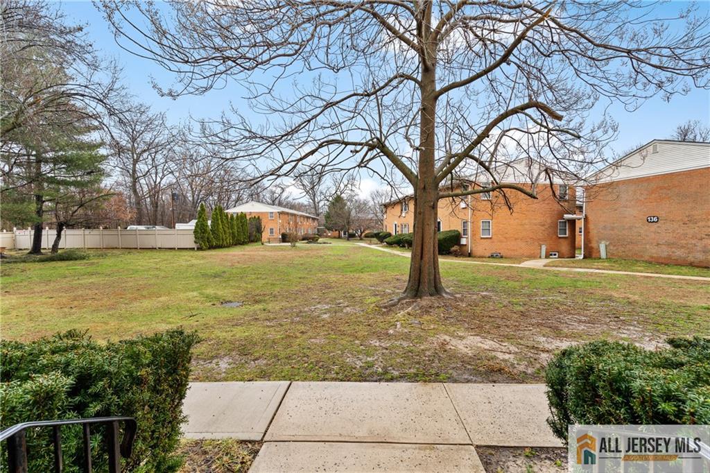 132 The Orchard, Unit L Cranbury, NJ 08512 - Photo 8 of 10 a view of a yard with an trees