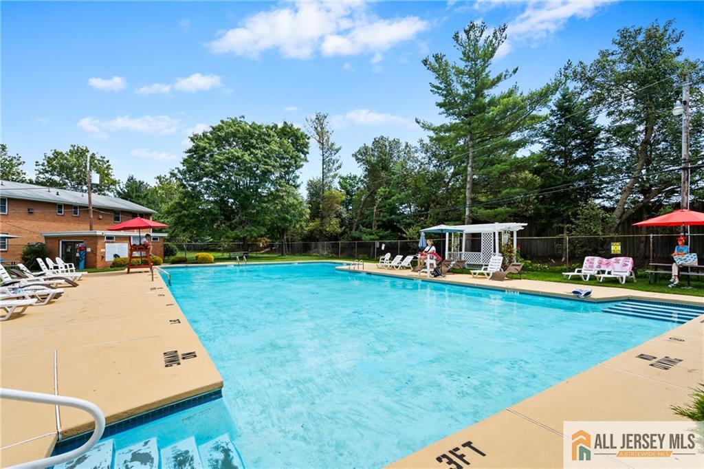 132 The Orchard, Unit L Cranbury, NJ 08512 - Photo 10 of 10 a view of a house with pool and a yard