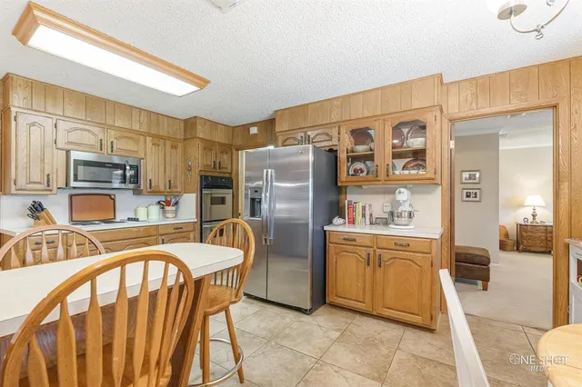 a spacious bathroom with a granite countertop double vanity and a mirror