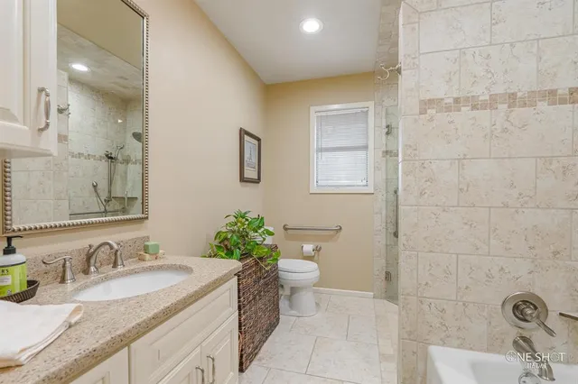 a bedroom with a baby bed and a chandelier