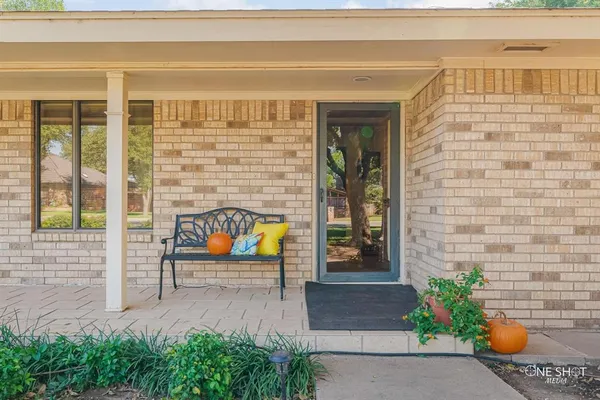 a living room with furniture fireplace and a large window