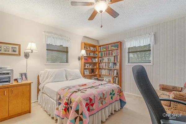 a view of a patio with couches chairs and wooden floor