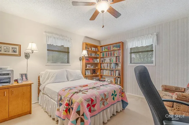 a view of a patio with couches chairs and wooden floor