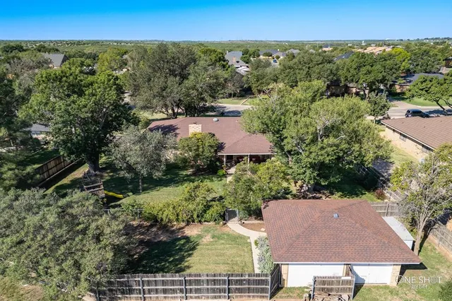 an aerial view of residential houses with outdoor space and ocean view