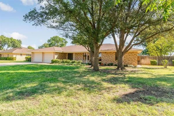 a living room with furniture and a lamp