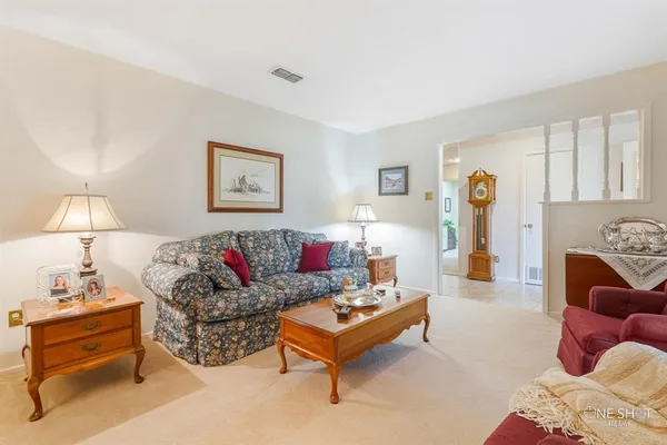 a view of a dining room with furniture and chandelier