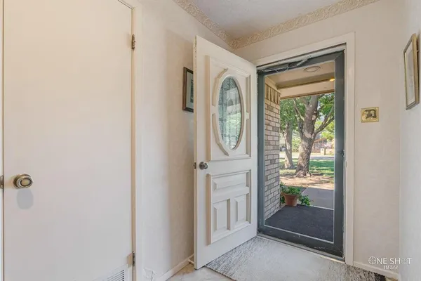 a living room with furniture a flat screen tv and a chandelier