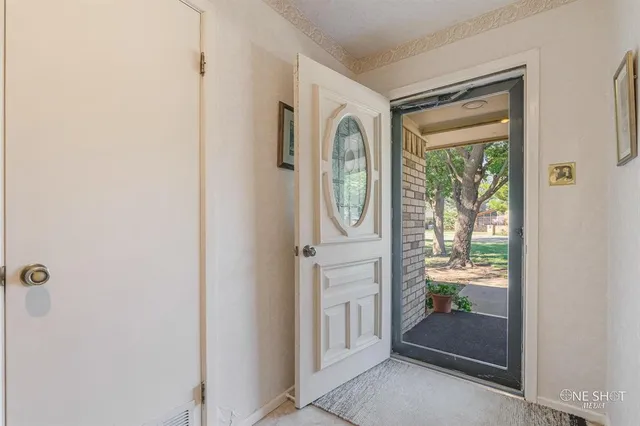 a living room with furniture a flat screen tv and a chandelier
