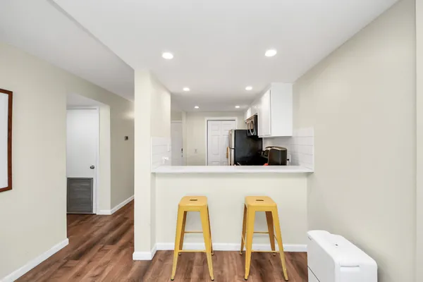 a view of kitchen with furniture and wooden floor