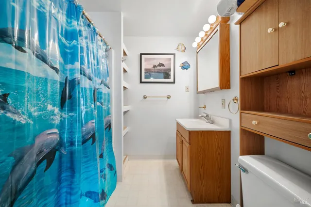 a bathroom with a sink and mirror with bathtub